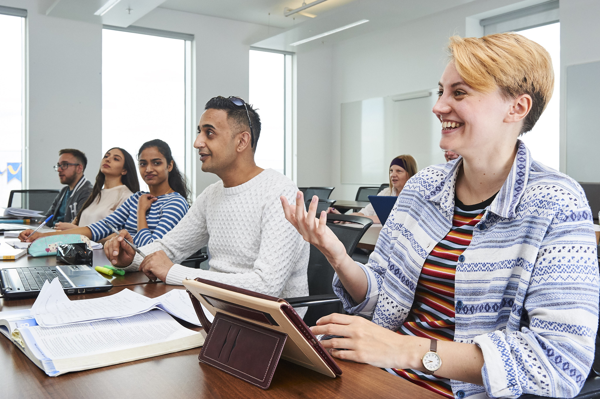 Education suite used by the School of Business, with students at desks writing in notebooks and using digital tablets