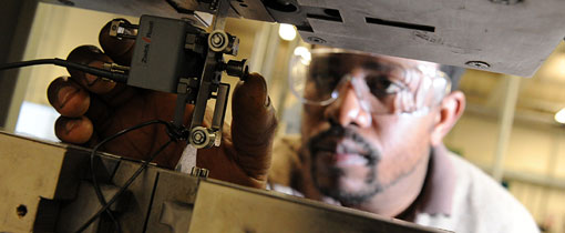 A student wearing safety goggles while using machinery