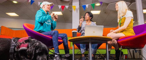 Two students sat down using sign language