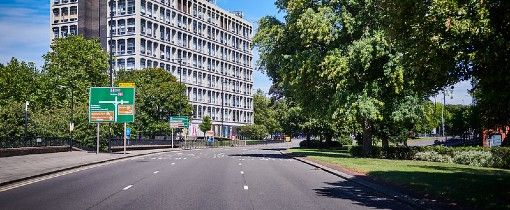 Roads outside the University of Wolverhampton, a sign visible at the side of the road with a large building in the distance