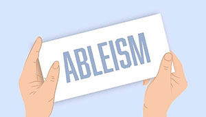 Close up image of a pair of hands holding a white card with the word 