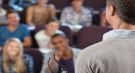 A lecturer speaking to a crowd of students