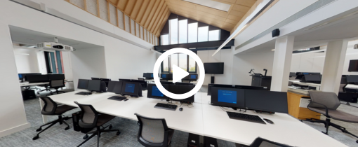 Woman sitting in the library with a phone in her hand