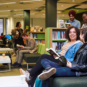 group of students looking at books in the library