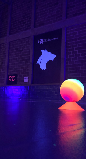 UV dodgeball equipment lighting up a darkened City Campus sports hall