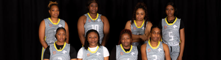 The womens basketball team lined up in uniform