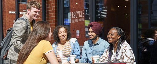 Photo of students sat outside Starbucks at City Campus