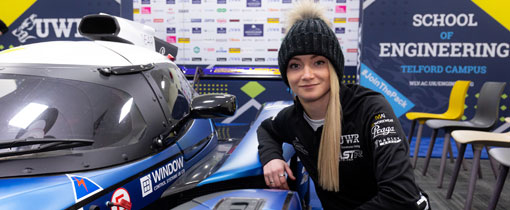A photograph of Jessica Hawkins, one of the UWR team racing drivers with the Praga R1 car