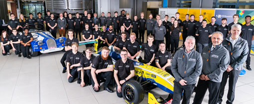 University of Wolverhampton Racing Team, wearing matching uniforms and standing around cars